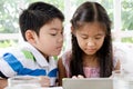 Little asian Girl and boy with tablet computer