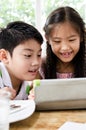 Little asian Girl and boy with tablet computer