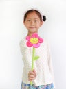 Little Asian girl child giving artificial flower for you on white background Royalty Free Stock Photo