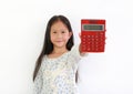 Little Asian girl child showing Calculator on white background. Kid holding a red calculator Royalty Free Stock Photo