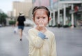 Little asian girl covering her mouth and nose with her hand Royalty Free Stock Photo