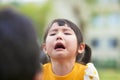 Little asian girl crying and look at her parents Royalty Free Stock Photo