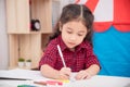 Girl drawing picture by color marker on table Royalty Free Stock Photo