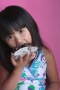 Little Asian Girl Eating Brownie Royalty Free Stock Photo