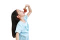 Little asian girl eating purple grape on white background. Kid holding bunch of grapes in the mouth Royalty Free Stock Photo