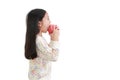 Little asian girl eating red apple over white background. Side view Royalty Free Stock Photo