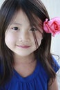 Little asian girl with flower in her ear Royalty Free Stock Photo