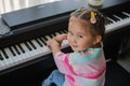 Little asian girl is happy playing the piano Royalty Free Stock Photo