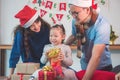 Little girl and her parents open christmas gift boxes Royalty Free Stock Photo