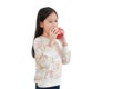 Little asian girl holding and bite red apple over white background Royalty Free Stock Photo