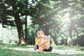 Little asian girl hugging her teddy bear in a park. Royalty Free Stock Photo