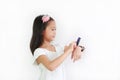 Little Asian girl kid using smart watch video camera against white background Royalty Free Stock Photo