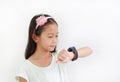 Little Asian girl kid using smart watch video camera against white background Royalty Free Stock Photo