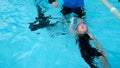 A girl learn how to swim in swimming class Royalty Free Stock Photo