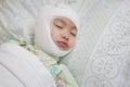 Little asian girl lying sick with bandaged head on bed at hospital. Baby girl injury and headache