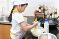 Little asian girl making pancake