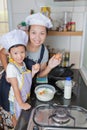 Little asian girl making pancake