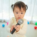 Little asian girl with microphone Royalty Free Stock Photo