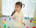 Little asian girl with microphone