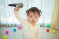 Little asian girl with microphone Royalty Free Stock Photo