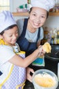 Little asian girl and mother making pancake