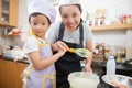 Little asian girl and mother making pancake