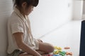 Little asian girl play with colorful toy. Kids play with educational toys at home