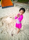 Little asian girl playing on the beach. Vacation and relaxing concept Royalty Free Stock Photo