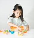 Little Asian girl playing colorful wood blocks Royalty Free Stock Photo