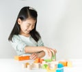 Little Asian girl playing colorful wood blocks Royalty Free Stock Photo