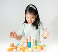 Little Asian girl playing colorful wood blocks Royalty Free Stock Photo