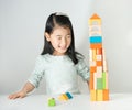 Little Asian girl playing colorful wood blocks Royalty Free Stock Photo