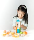 Little Asian girl playing colorful wood blocks Royalty Free Stock Photo