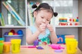 Girl playing dough at school