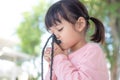 Little asian girl praying with holding the cross, christian concept Royalty Free Stock Photo