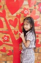 Little Asian girl and red heart love tree. Royalty Free Stock Photo