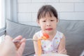 Little girl refuse to eat tomato in spagethi from her mother Royalty Free Stock Photo