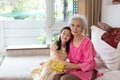 Little asian girl and senior woman at home celebration together Royalty Free Stock Photo
