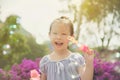 Girl smiling while blowing bubles in park