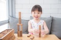 Girl smiling while playing wooden blocks on table Royalty Free Stock Photo