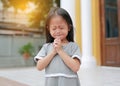Little asian girl stance praying in the garden at the morning. Little kid girl hand praying, Hands folded in prayer concept for