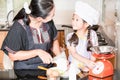 Little asian girl stir wheat flour making pancake
