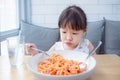 Girl with unhappy face while having fried spaghetti