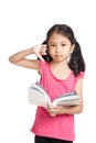 Little asian girl unhappy show thumbs down read a book Royalty Free Stock Photo