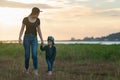 Little asian girl walking in the nature with her mom, Mother holding hands of her daughter Royalty Free Stock Photo