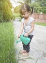 Little asian girl watering plants Royalty Free Stock Photo