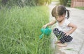 Little asian girl watering plants Royalty Free Stock Photo