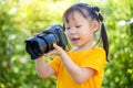 Little girl taking photo by camera in park Royalty Free Stock Photo