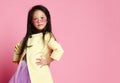 Little asian girl in yellow fashion jacket purple dress and modern red sunglasses posing Royalty Free Stock Photo