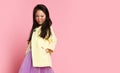 Little asian girl in yellow fashion jacket purple dress and modern red sunglasses posing Royalty Free Stock Photo